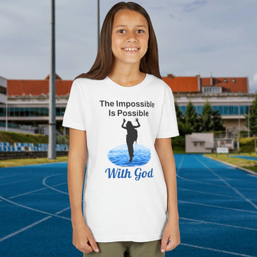 Bella+Canvas youth unisex t-shirt with “Impossible Girl” design featuring a girl walking on water and uplifting message, Christian apparel made from soft cotton, ideal for active wear and faith-forward style, 2nd girl in white t-shirt